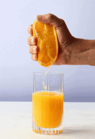 Image of a man squeezing an orange with the juice funneling into a tall juice class. Iconography for SEO juice. 